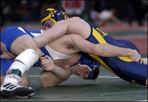 Anthony Wayne's Caleb Metcalf, bottom, tries to get control of Olmsted Falls' Ryan Smith in the semifinals. Metcalf lost 8-4.