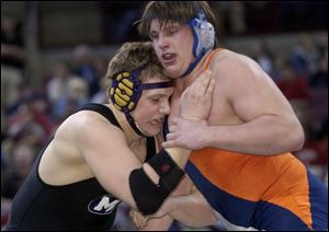 Maumee's Brett Boggs, left, battles Galion's Dustin Fox in the 275-pound title match. Fox won 4-2 in overtime.