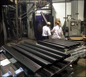 Bumpers for Jeep Wranglers are stacked ready for shipment after completing the coating process in Monclova Township.