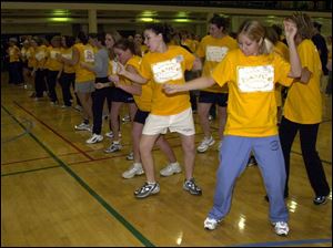 cty photo by don simmons mar 1, 2003  corey miller ( white shorts )  and jenny meyer ( blue sweats ) along with many others attend the dance marathron held at the university of toledo student rec center to raise money for the  children's miracle network