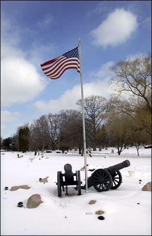 Military graves and artifacts honor veterans at historic Woodlawn Cemetery.