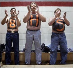 From left, Bettsville basketball parents Tim Weber, David Hawk and Bob Green spell out their support during a sectional game against New Riegel. But not even these drastic measures worked.