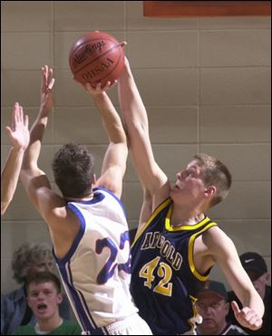 Archbold's Joel Ruffer blocks a shot attempt by Liberty-Benton's Chad Edel. Ruffer had 12 points and 9 rebounds.