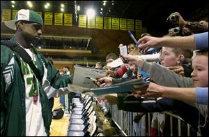 LeBron James signs autographs after Akron St. Vincent-St. Mary's victory last night.