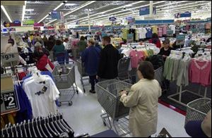 Shoppers crowd the aisles at the Navarre Ave., Wal-Mart yesterday.