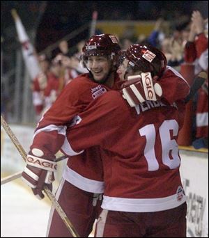 Wes Mason, left, and Tim Verbeek celebrate Verbeek's third-period goal that gave the Storm a 3-1 lead. It was Verbeek's third playoff goal.