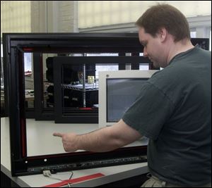 Dan Wedding tests a touch-screen at Imaging Systems Technology Inc., considered one of the incubator's graduates.