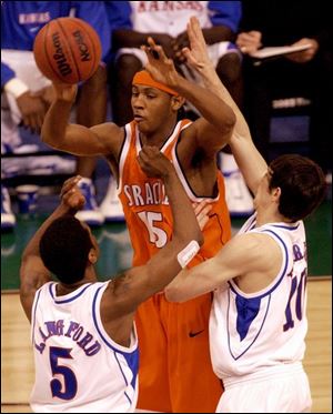 Syracuse's Carmelo Anthony (20 points, 10 rebounds, 7 assists) passes over Kansas' Keith Langford and Kirk Hinrich.