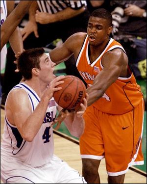 Kansas senior Nick Collison drives against Syracuse's Jeremy McNeil. Collison finished with 19 points and 21 rebounds. 