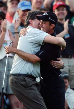 Canadian Mike Weir, right, celebrates with his father, Rich, after winning the Masters over Len Mattiace in a one-hole playoff. 
