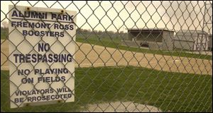 A sign at the Fremont Ross High School softball field warns against trespassing. More than a dozen animals, which police believe were roadkill, were found scattered on the field.