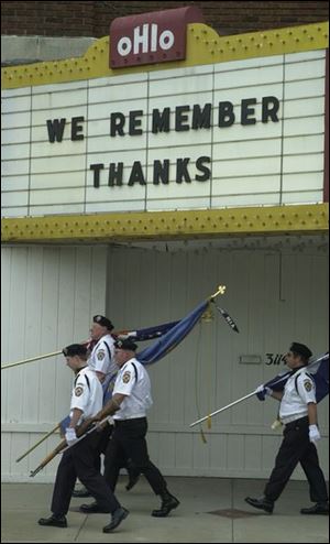 A color guard from Toledo Catholic War Veterans Post 1675 passes under the marquee of the Ohio Theatre before taking part in the Lagrange-area parade.