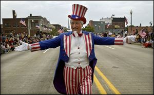Uncle Sam, portrayed by Dave Lyke of Monroe, marches in the parade there.