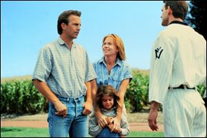 Kevin Costner, left, with Amy Madigan and Gaby Hoffman, speaks with Dwier Brown in the 1989 baseball drama Field of Dreams, which will be shown at Fifth Third Field.