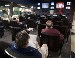 Horse racing enthusiasts enjoy the confines at Toledo Raceway Park, where they can keep tabs on their favorites with the aid of racetrack television monitors.