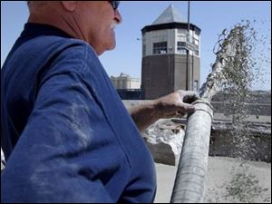 ROV cementing 01 - Dain Thunert, sprays a mixture of water, cement and foam into the bottom of the Martin Luther King bridge, to replace the tons of sand and gravel that filled the bridge before. This mixture, all 11,000 cubic yerds of it, will fill the bridge, and wil be covered with stone, cement and blacktop. The Blade/Allan Detrich