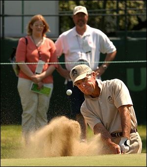 Gary Player shows some of the 21,000 who watched the pros practice at Inverness how an expert gets out of the sand.