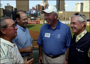 From left, Tom Meeks and Mike Davis of the U.S. Golf Association chat with Marc Stockwell of Inverness Club and U.S. Senior Open golfer Jay Overton at Fifth Third Field.

