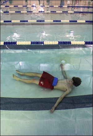 In a training session, a lifeguard lies at the bottom of a pool equipped with the Poseidon system in Medina, Ohio.