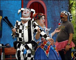 Marquis Zanny from Zanzibar (Mark Reed), left, and Ima Nutte (Tara Reed) teach Bill Lehan, who they named Dim Wit, how to be a medieval fool in fool school at the Medieval Fantasy Faire at 1313 Tiffin St. in Fremont.