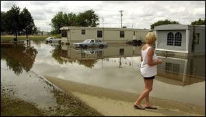 Jane Ford surveys the high water in Rockford, Ohio. Floodwaters have damaged about 100 homes in Mercer County.