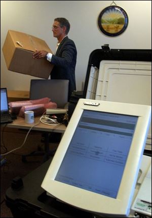 Joe Nista unpacks the new electronic voting machines at the county Board of Elections office in Government Center.