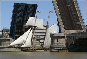 The Martin Luther King, Jr., Bridge opens to allow one of the Tall Ships to pass along the Maumee River to its destination at International Park. 