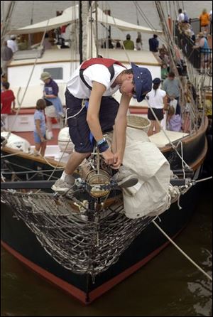 Kyle Matthews, 17, of Ottawa, Ont., and an officer-in-training aboard the Fair Jeanne, lashes a shackle on the jib boom. He says that he gets a `feeling of freedom' from the sailing life.