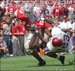 Ohio State's Maurice Clarett sheds an Indiana defender on his way to a touchdown. He led the Buckeyes with 18 TDs.