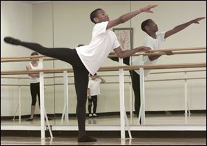 Alexander Catchings, 15, demonstrates an action pose in the Toledo Ballet studio.