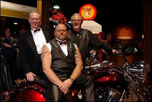 CYCLE SOIREE: From left, Don Harbaugh, Mark Moses, and Mel Harbaugh, Jr., get ready for their motorcycle shop's grand opening.