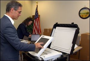 An electronic voting system designed by Diebold Elections Systems of North Canton, Ohio, gets a tryout as it arrives at the Lucas County Board of Elections. Besides those delivered last week, 445 more are expected to arrive by the end of the month.