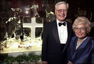 ICE BREAKER: Bill and Gene Parker, members since 1968, check out the ice sculpture in the form of the crest of the club, which was celebrating its centennial anniversary Saturday night.