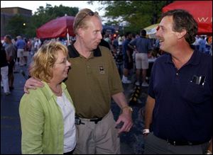 PART OF THE PARTY: Carol and John Cochrane chat with John Hadley at the Party in the Parking Lot.
