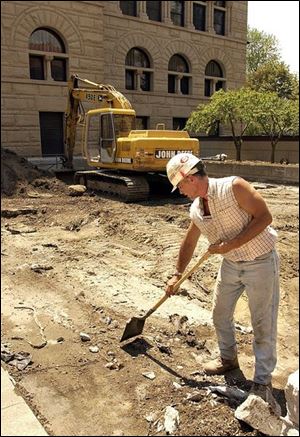 Tim Franks of Mosser Construction clears the work area for the atrium to be constructed that will connect three buildings at the Wood County Courthouse in Bowling Green.