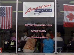 People wait inside the American Drug Club in Livonia, Mich., hoping to get a better price on prescription drugs. The club offers cheaper, government-subsidized prescription drugs from Canada via American Drug Co. of Winnipeg, Canada.