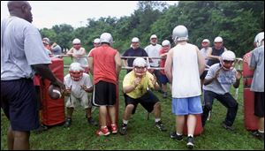 Defensive coordinator Aaron Purdie watches Bowsher players go through some opening-day practice drills.
