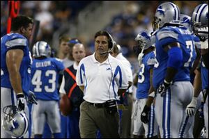 New Lions coach Steve Mariucci prowls the sidelines. His defense played well and a well executed two-minute-drill touchdown put his team ahead.