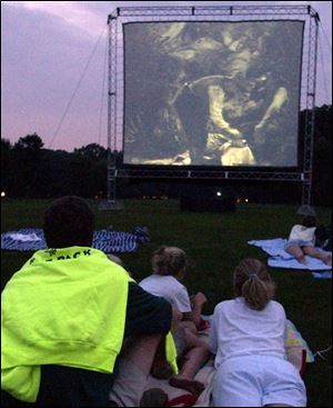 EVENING FUN: From left, Richard, Claire and Denise Arnos of Ottawa Hills enjoy a drive-in movie.