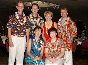HAWAIIAN FUN: At Flower Hospital Auxiliary's ‘Flower Luau' for tropical food and entertainment are, standing from left, Paul Knake, Ken and Jean Lovejoy, and Neal Barnard. Sitting, from left, are Mary Beth Knake and Carol Barnard.
