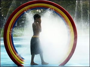 ROV Water Park  August 12, 2003-- Kisora Myers, 8, cools off in the water park at Savage Park on Nebraska Avenue Tuesday afternoon. Blade photo by Andy Morrison