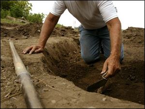 Gary Johannsen of the Ohio Archaeology Society digs at the site of an Indian home.