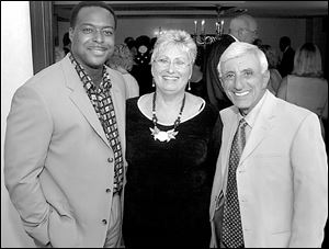 Jamie Farr, right, with his personal assistant, Sharon Toth, and CNN anchor Leon Harris during the Owens Corning Gala preparty at the Radisson Hotel.