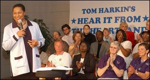 Former Illinois Sen. Carol Moseley-Braun, a Democratic presidential candidate, is applauded at Iowa Sen. Tom Harkin's “Heartland” forum in Waterloo, Iowa, on Aug. 3.