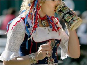 CTY germanfest 01 - Missy Krejci, of Cleveland has a drink in her german outfit at the German American Fest in Oregon. The Blade/Allan Detrich