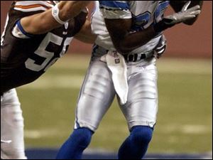 Browns linebacker Ben Taylor can't stop Lions rookie Charles Rogers from making a catch.