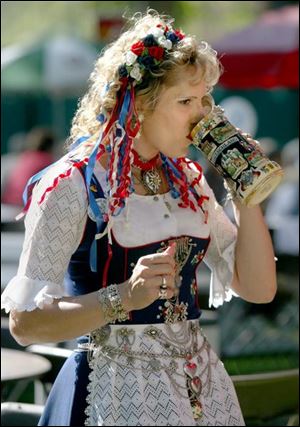 CTY germanfest 01 - Missy Krejci, of Cleveland has a drink in her german outfit at the German American Fest in Oregon. The Blade/Allan Detrich