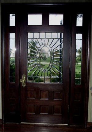 The beveled glass in Ken and Zoe Moore's front door, left, casts changing light patterns. 