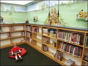 CTY August 27, 2003 - Evan Sandwisch, 5, of Elmore, sits under a mural painted by Denis Bortz in the children's area of the Harris-Elmore Public Library in Elmore.  The mural features sights and children from the community.  Evan is in the mural although on a wall not in the photograph.  Bortz an art teacher at Woodmore Elememtary.  Blade photo by Dave Zapotosky