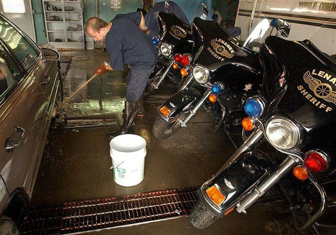 Kurt Kammer, an inmate at the Lenawee County jail, washes cars in the county garage.